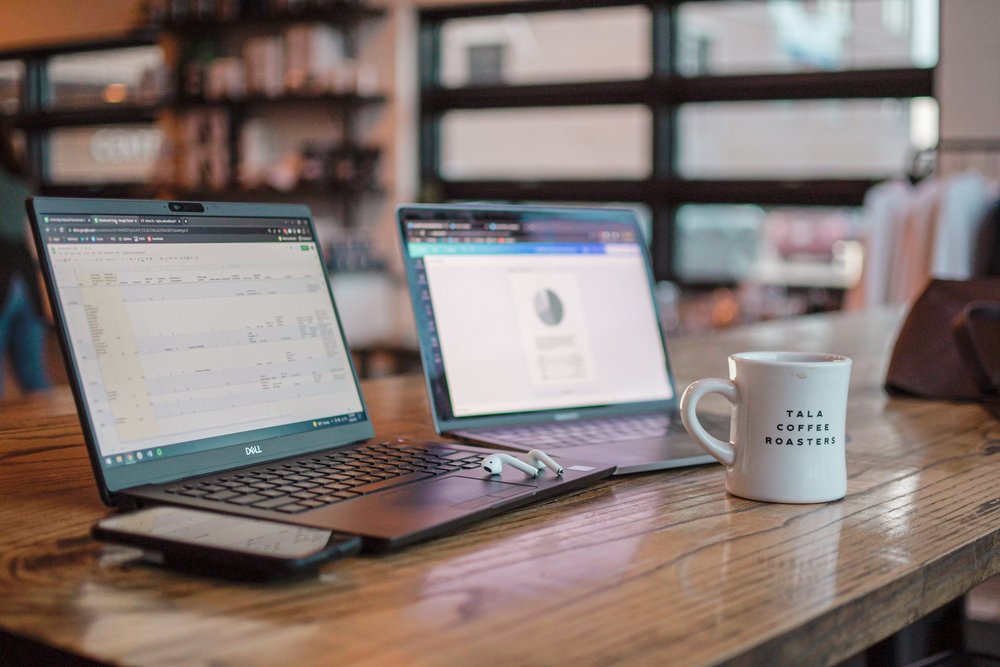 MacBook and Windows laptop side by side on a desk